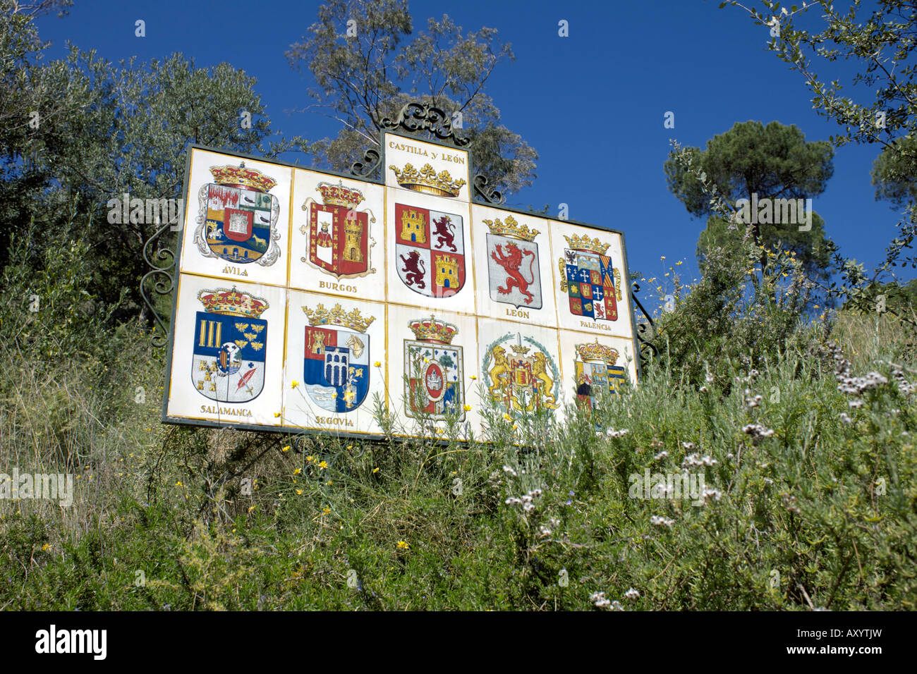 Notice board showing badges shields for Spanish cities place names regions of Spain Stock Photo