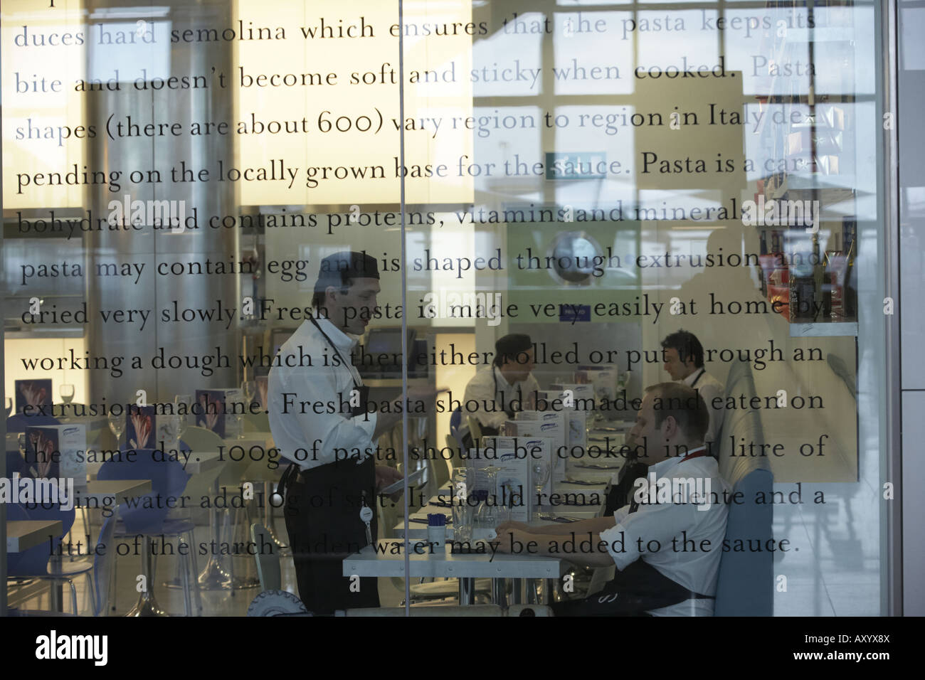 Waiters inside Carluccio's retail restaurant in landside Departures area of London Heathrow Airport's Terminal 5 building Stock Photo