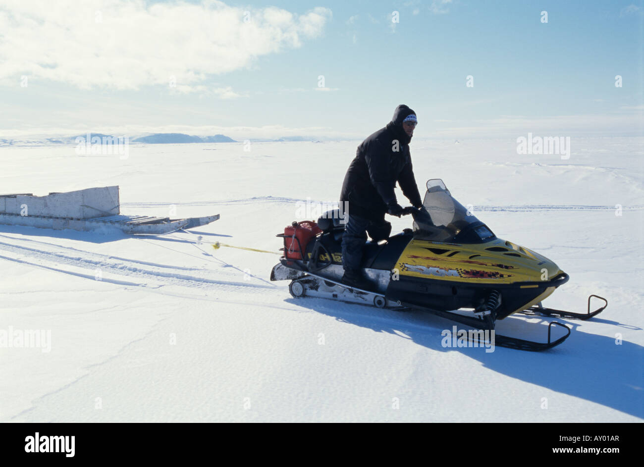 Inuit traveling on a snowmobile, Arctic Canada Stock Photo Alamy