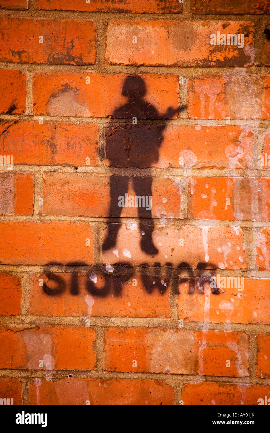 Anti-war graffiti on a brick wall Stock Photo
