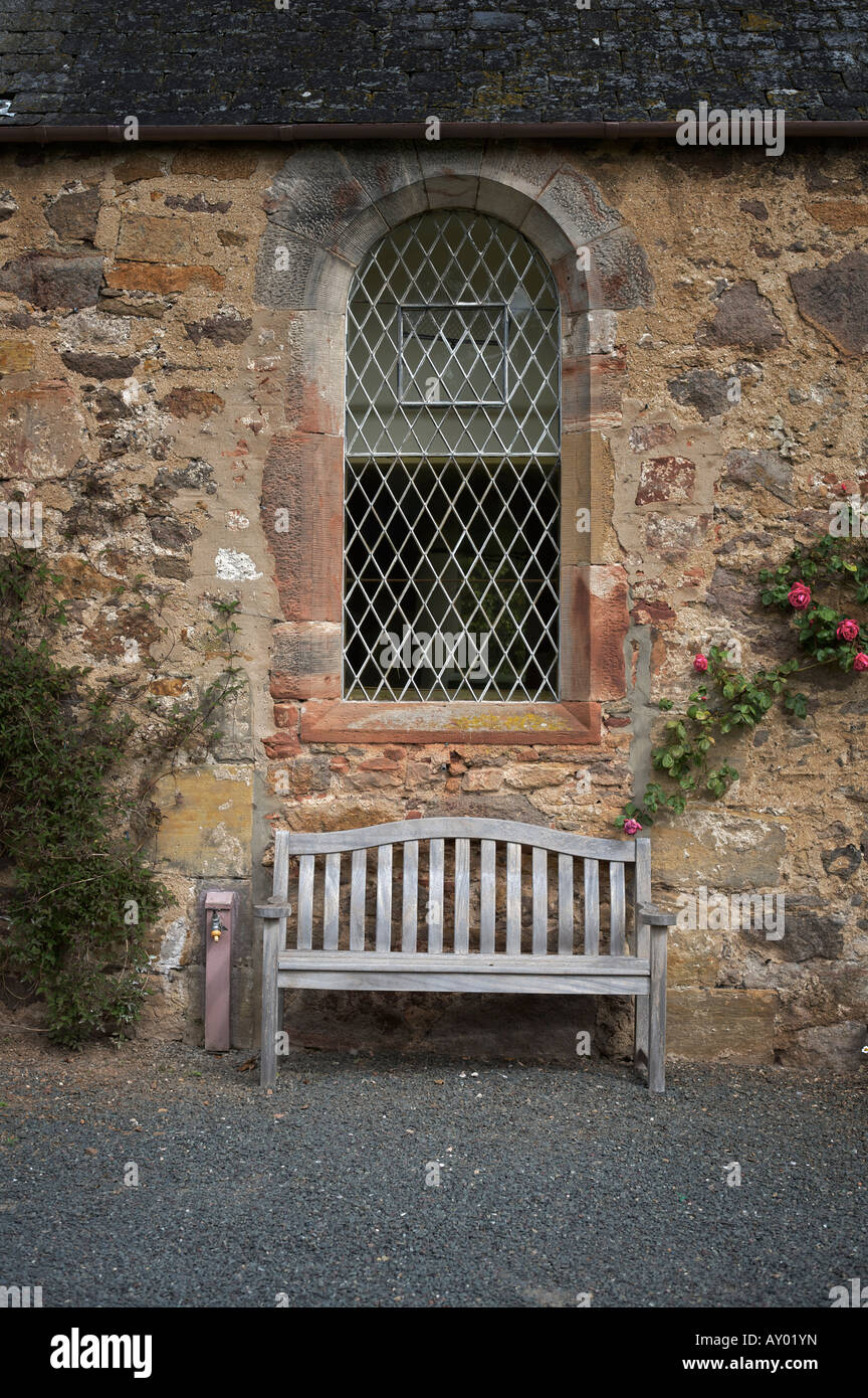 Bench and arched window at Dirleton Kirk. Dirleton, East Lothian, Scotland Stock Photo