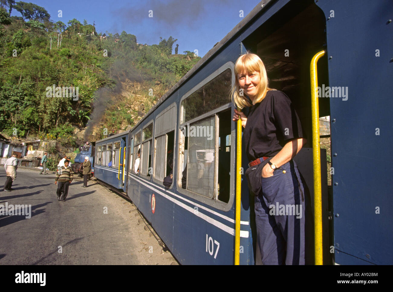 India Darjeeling West Bengal female western tourist on narrow guage toy train Stock Photo