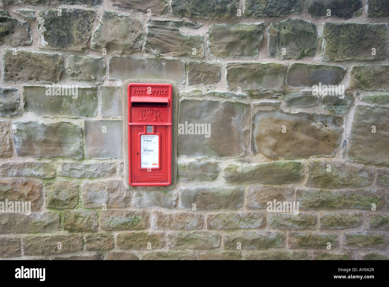 Queen Victoria, victorian red letter box mounted into a stone wall. Stock Photo