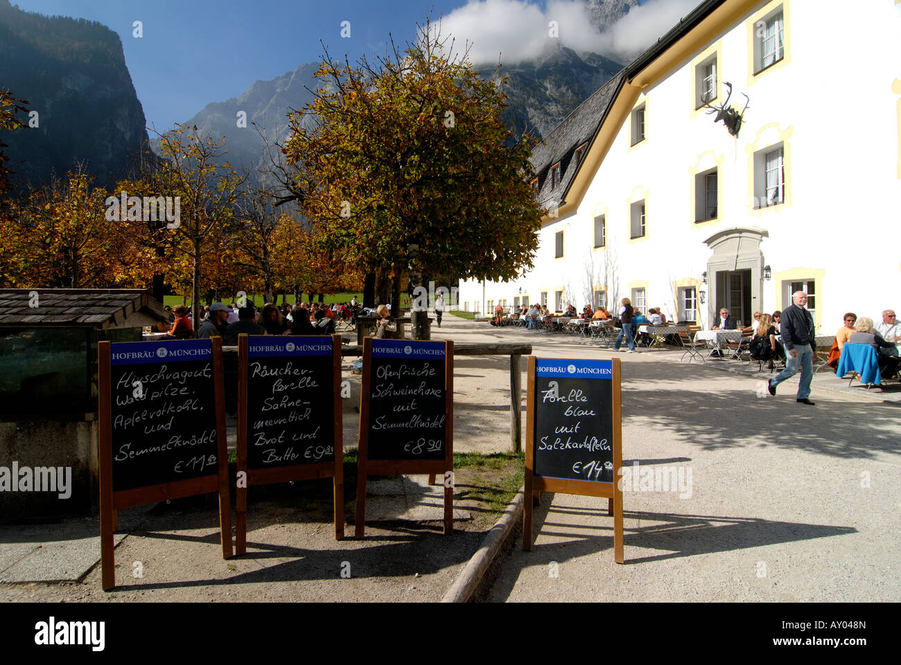 Beer garden in the St Bartholomä church on the Königssee in the background the Watzman Berchtesgadener land National park Stock Photo