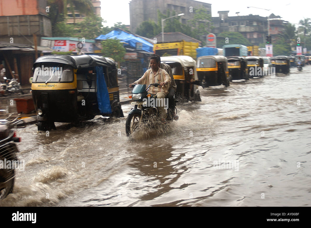 bike and autos flooded street after RAINS AT LBS MARG KURLA WEST MUMBAI MAHARASHTRA INDIA Stock Photo