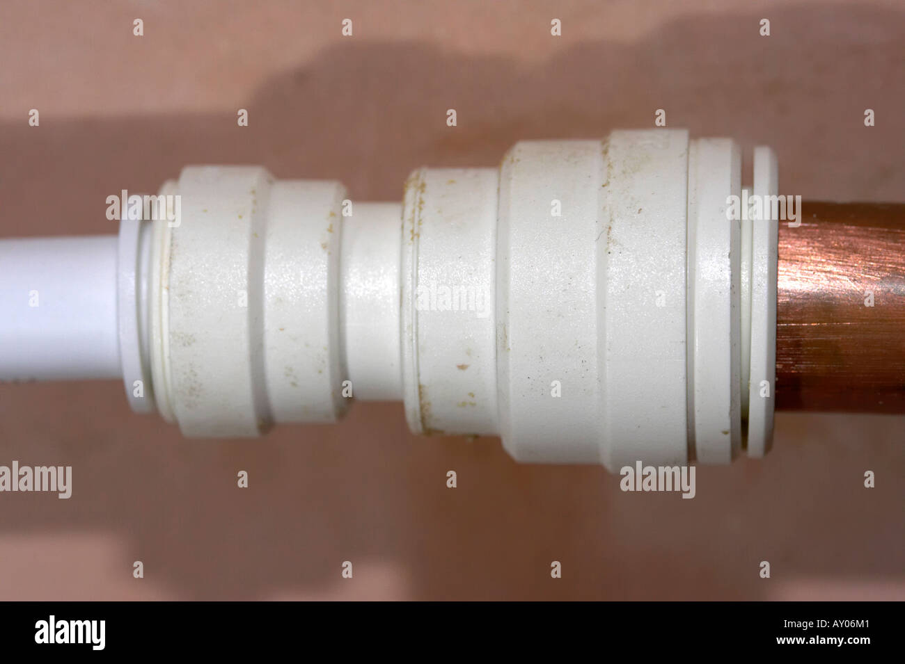 modern speedfit push fit plastic pipe fitting attached to old style