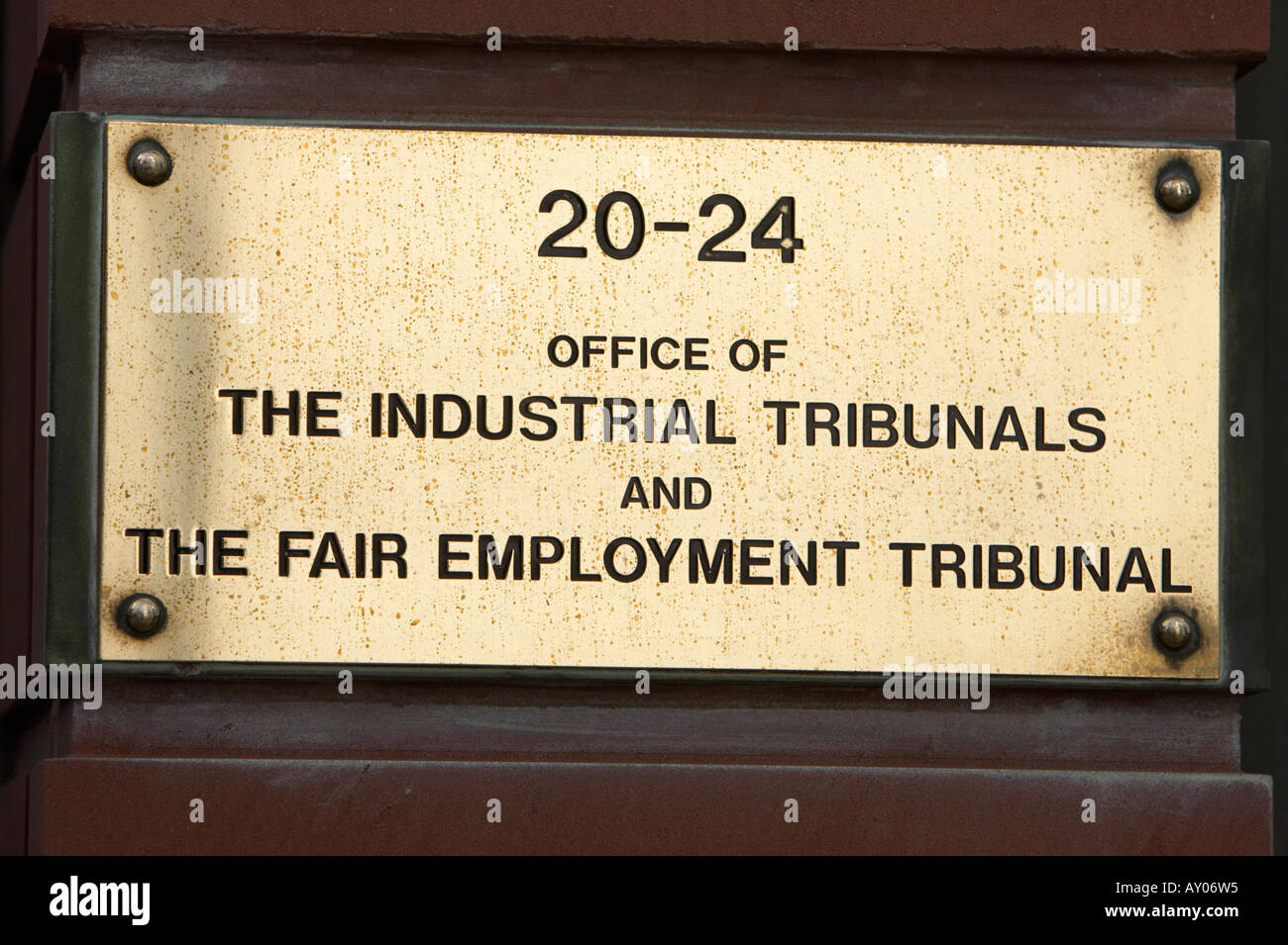 brass plaque at the entrance to the office of industrial tribunals and fair employment office tribunal offices belfast northern ireland Stock Photo