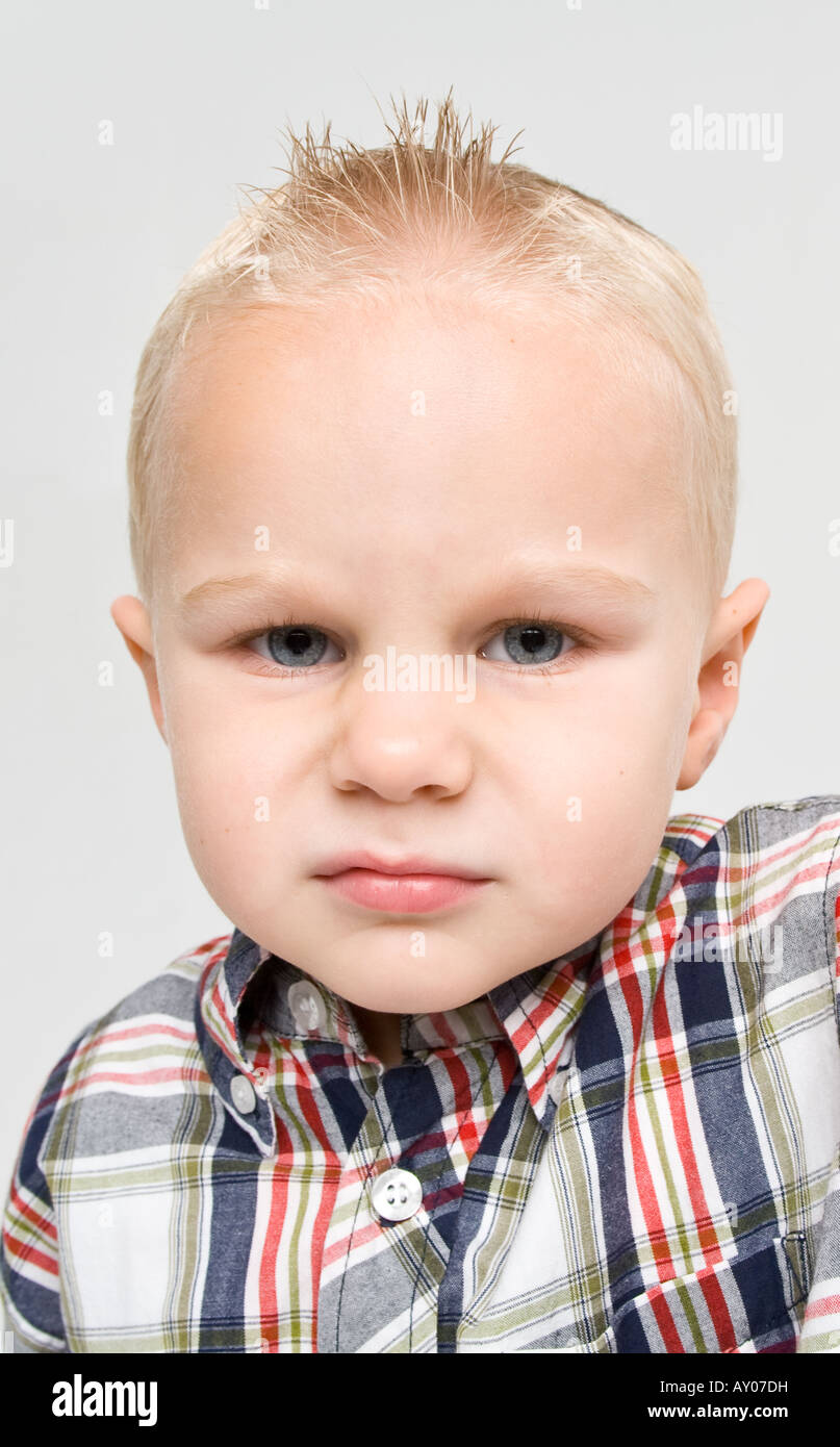 Small Boy With Sneer To Camera Looking Ugly And Angry Stock Photo
