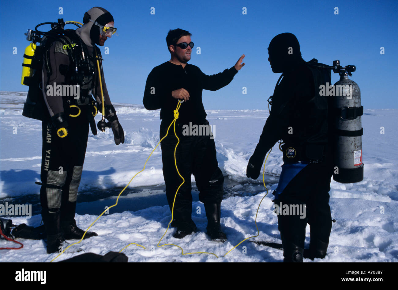 Divers ready to dive below arctic sea ice in Lancaster sound Stock Photo