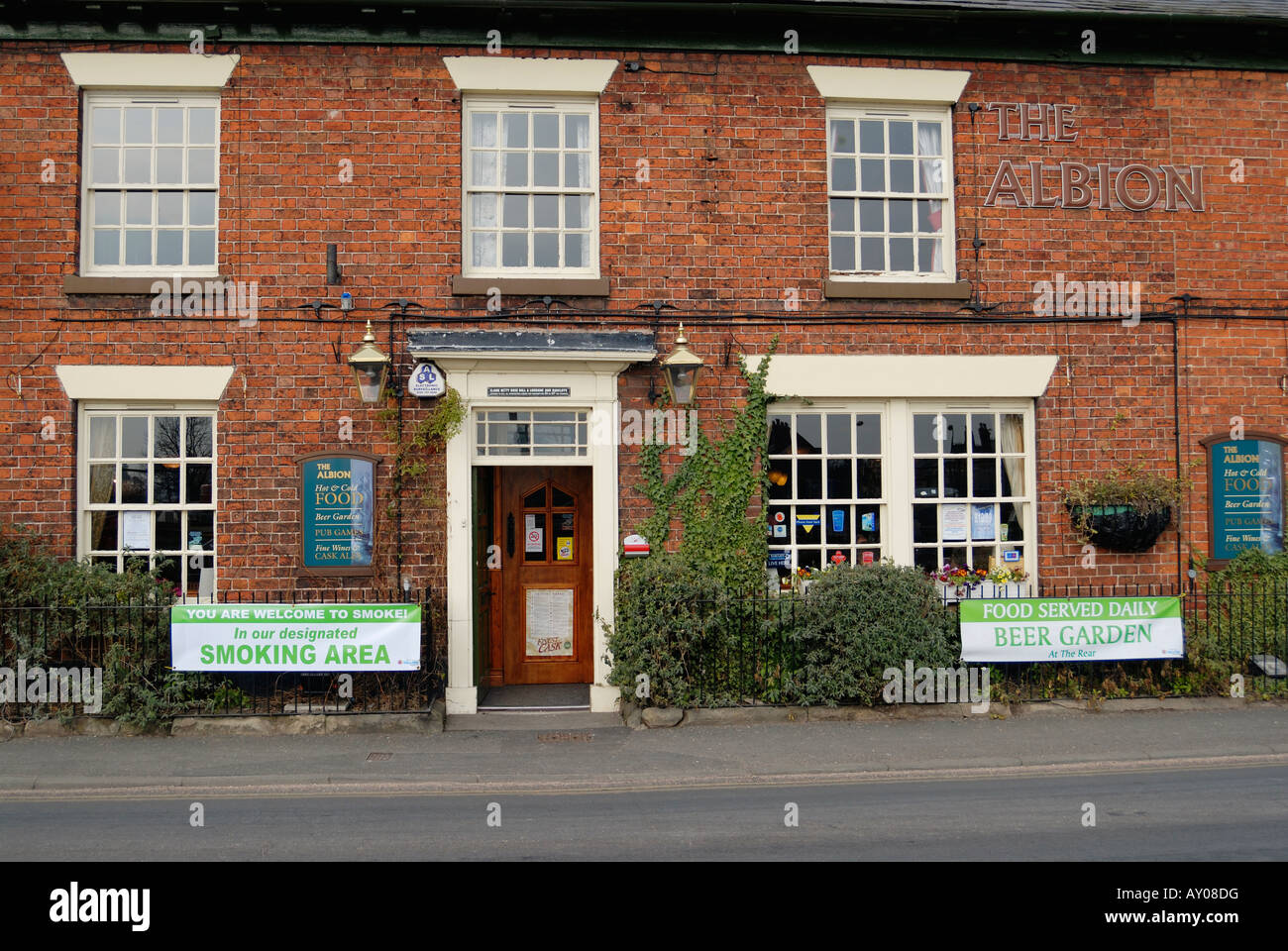The Albion public house in Wem Shropshire with banners advertising a smoking area. Stock Photo