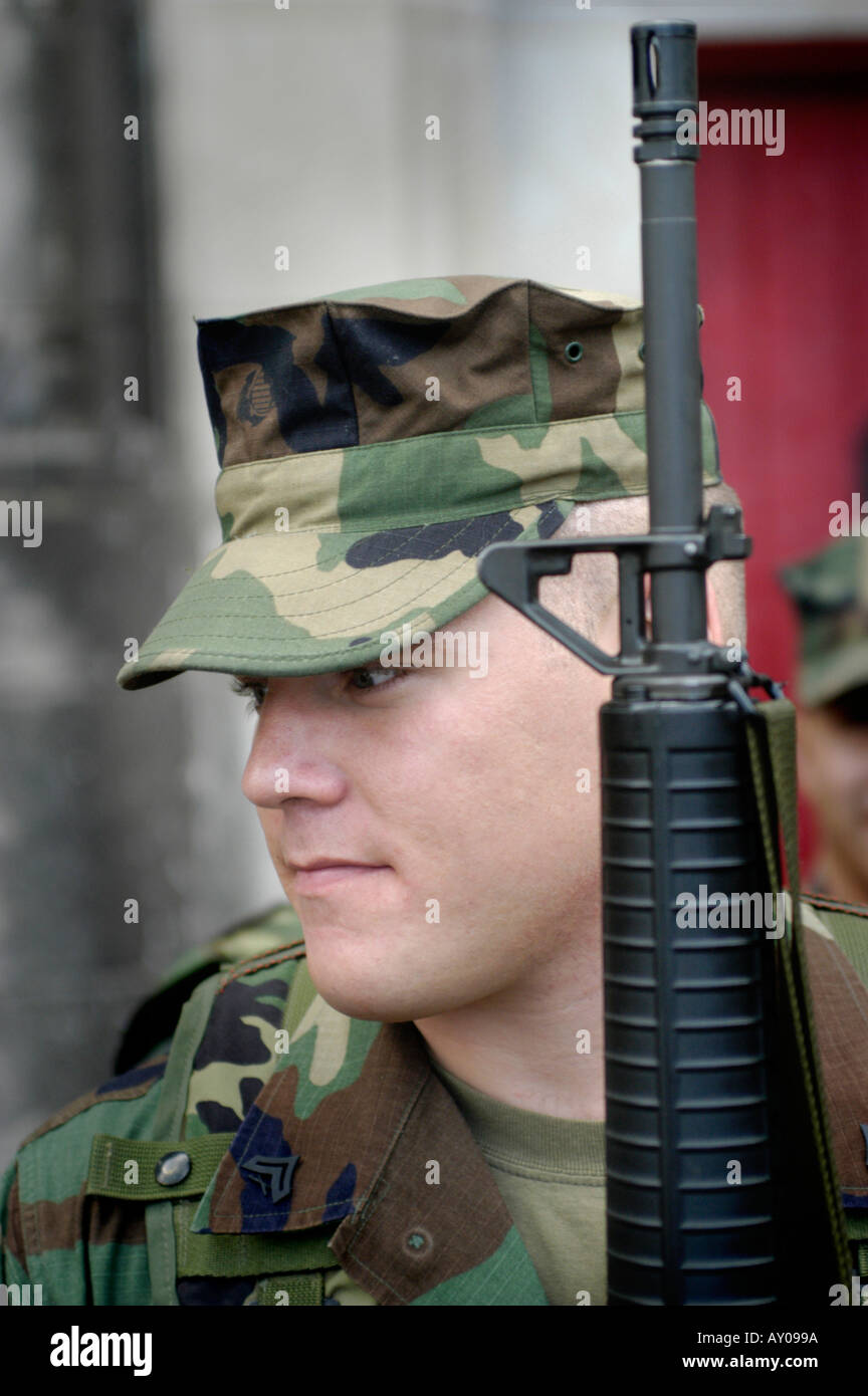 US Marine in camo clothes with guns, ready for home gathering