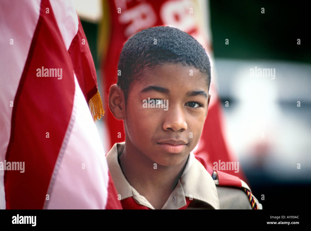African American Boy Scout with Flag looking at camera face Stock Photo
