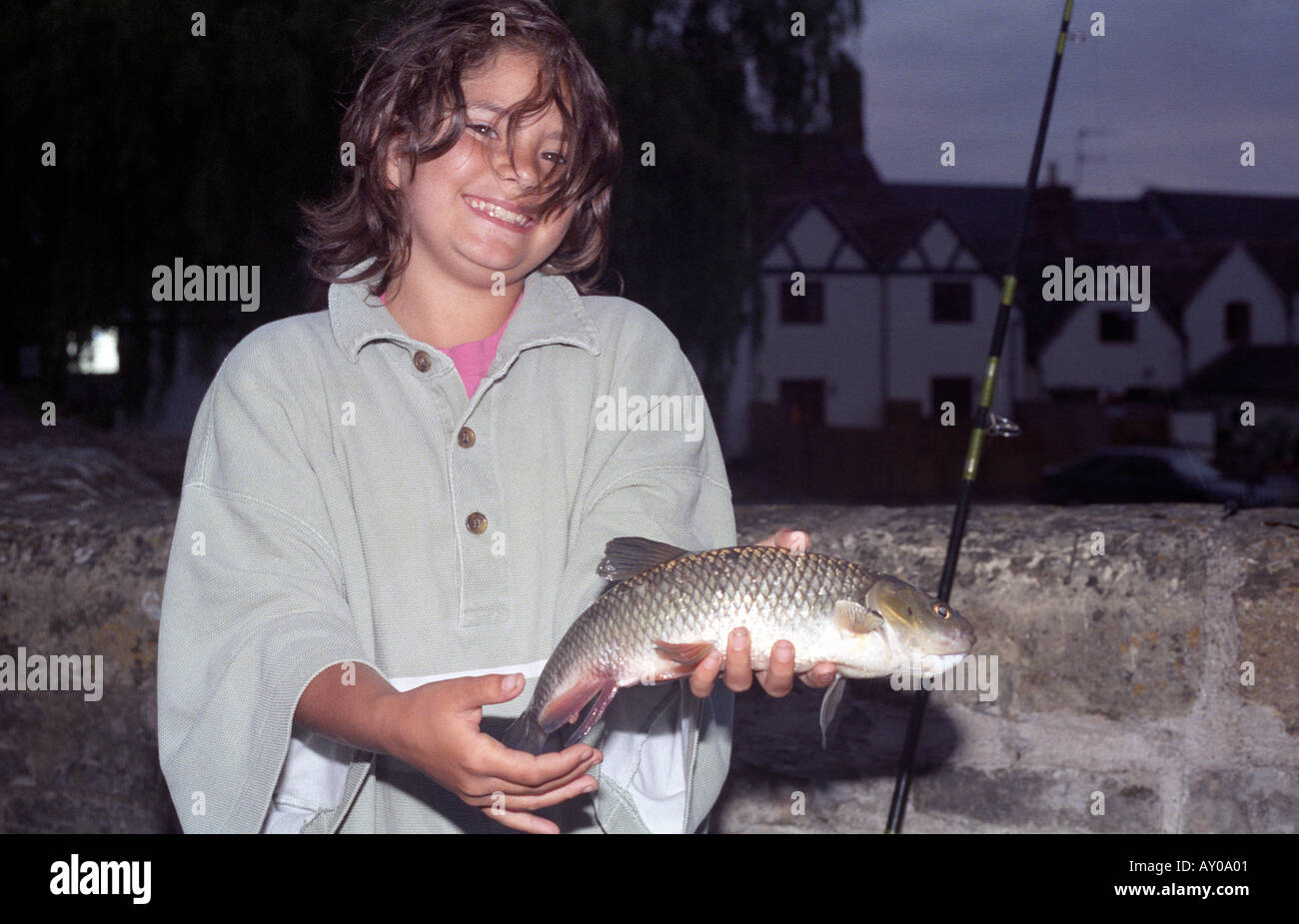 Girl with her first fish Stock Photo - Alamy
