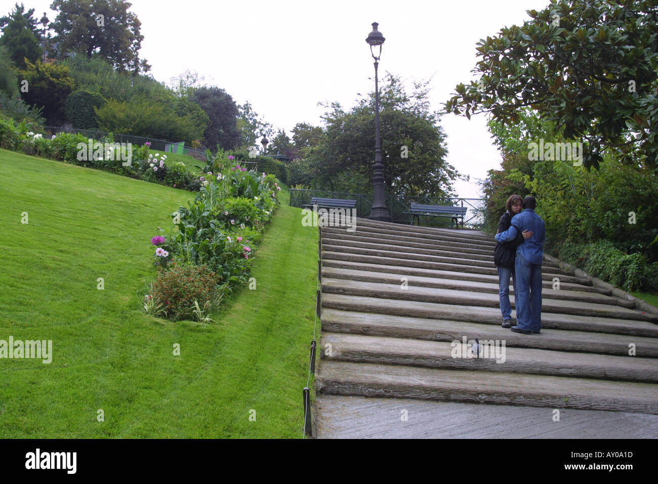 Young couple on steps to Sacre Coeur Paris Stock Photo