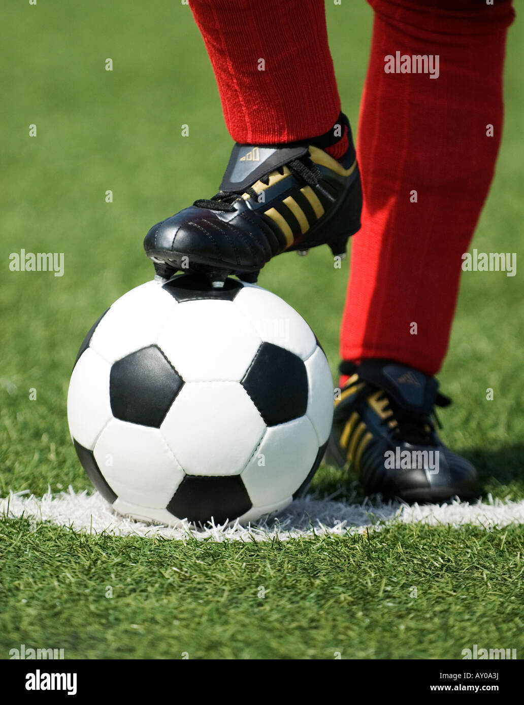 the feet of a football player in red stockings and a vintage black and