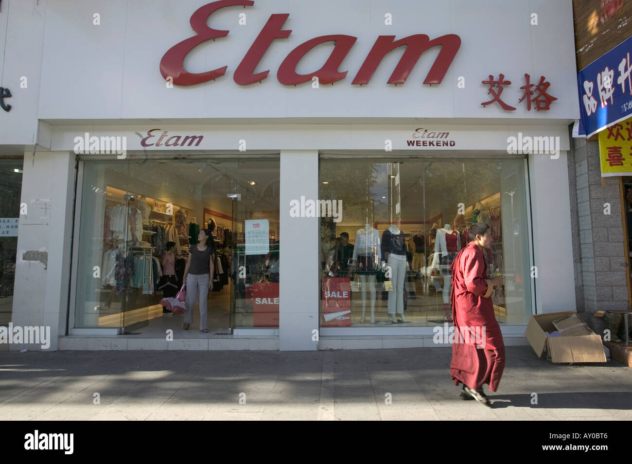 Monk walks past modern Etam clothes shop, Lhasa, Tibet Autonomous Region,  China. Sept 06 Stock Photo - Alamy