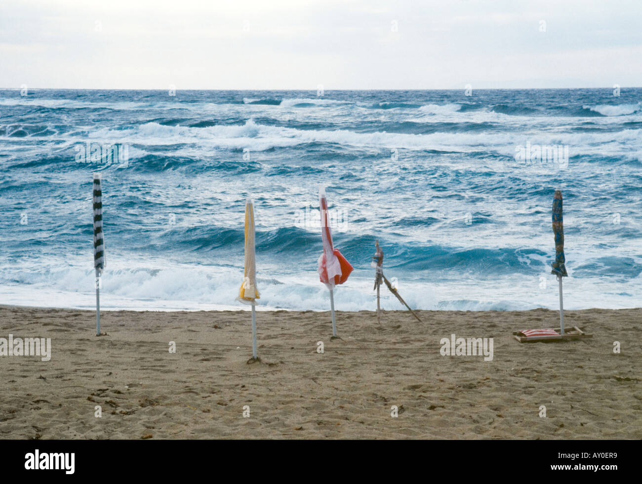 sea, waves, foam, moved, sky, beach, sand, sun umbrellas, colorful, closed Stock Photo