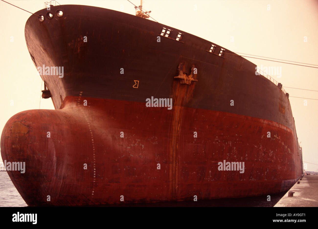 bow of oil tanker looking large at quayside in jebel ali port united arab emirates Stock Photo