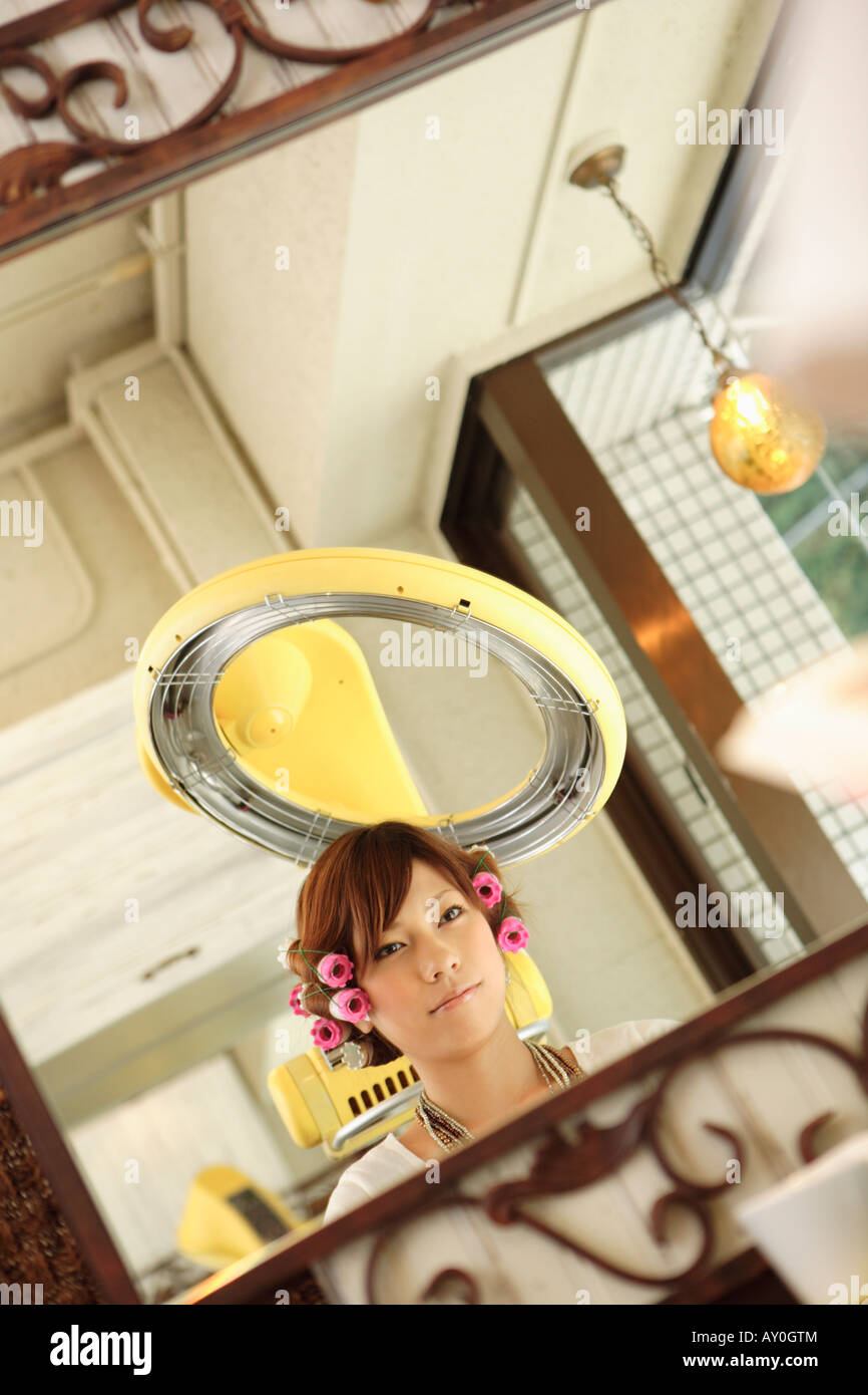Young woman having hair permed Stock Photo