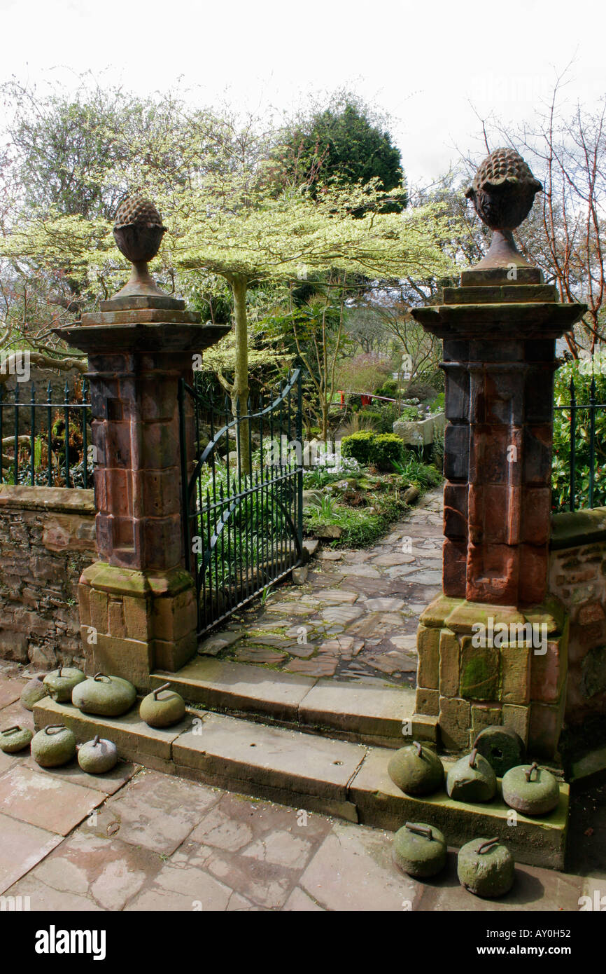 Old sandstone gate pillars with pineapple finials in E A Hornel's