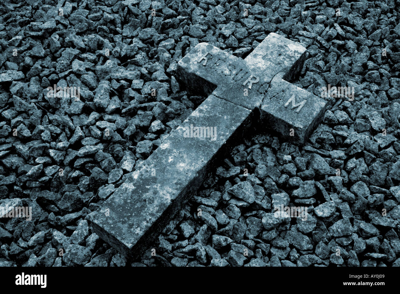 Old Stone Cross on ground Blue grey tone Stock Photo
