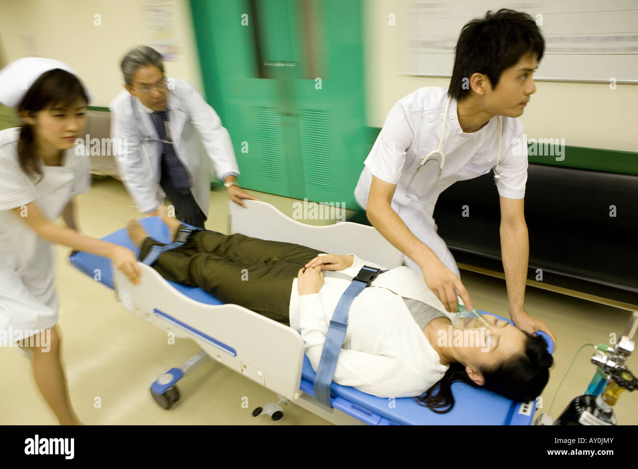 Doctor and nurses transporting patient on stretcher Stock Photo Alamy