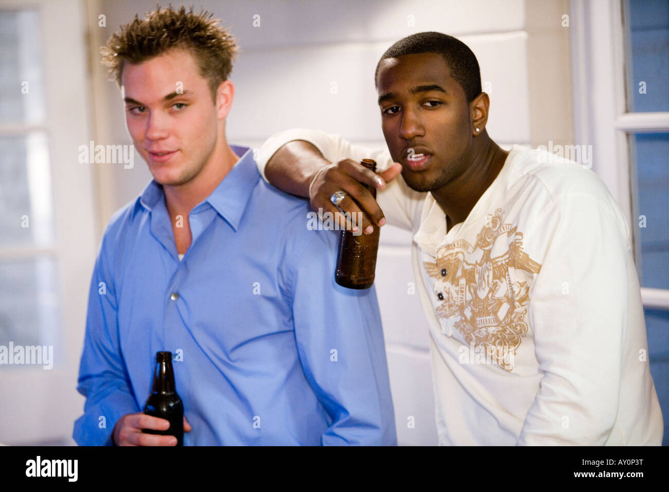 Two men holding up bottles hi-res stock photography and images - Alamy