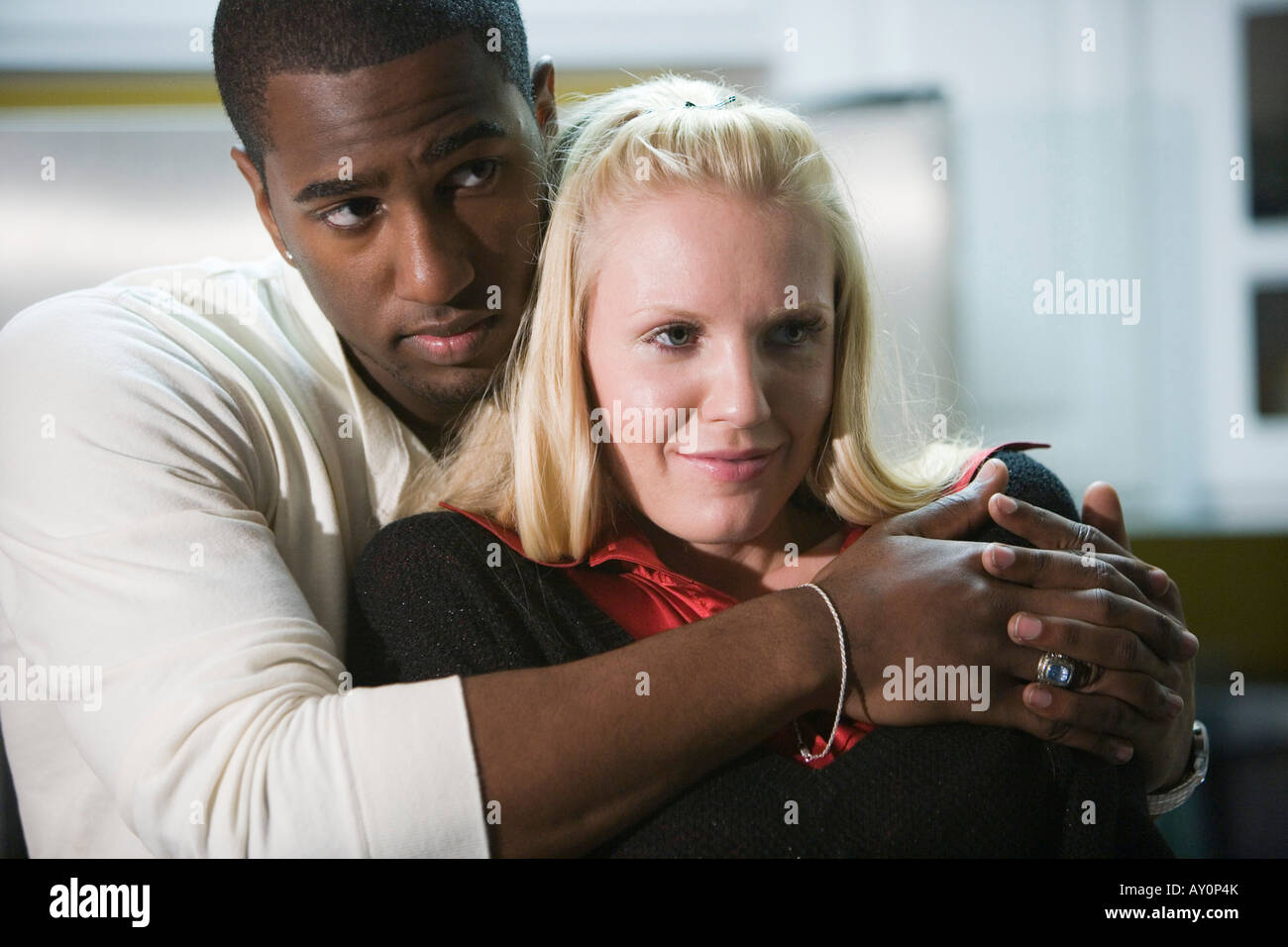 Young man embracing mid adult woman Stock Photo - Alamy