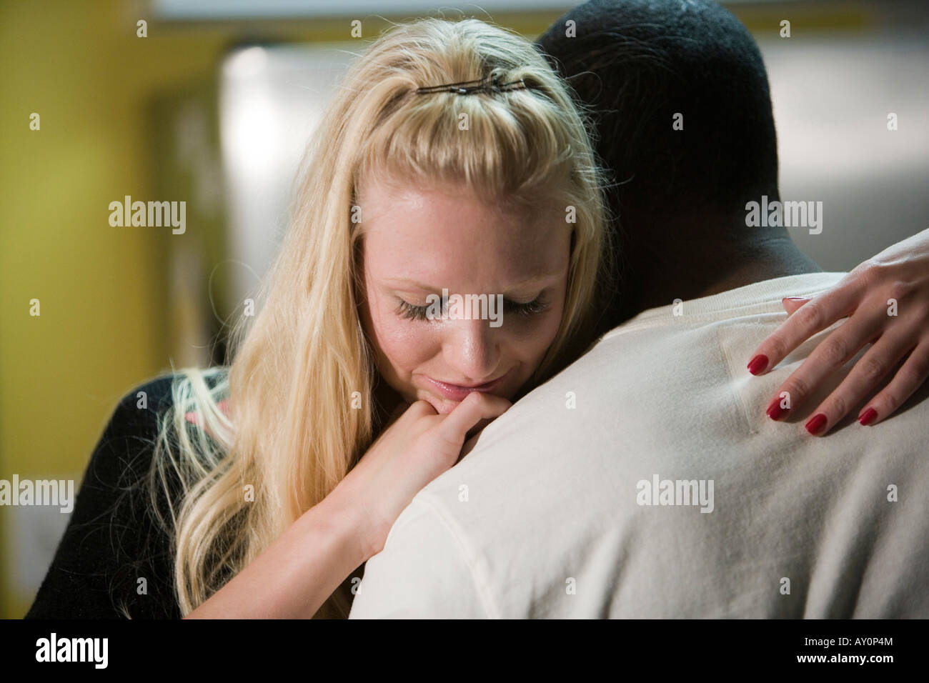 Mid adult woman embracing young man Stock Photo - Alamy