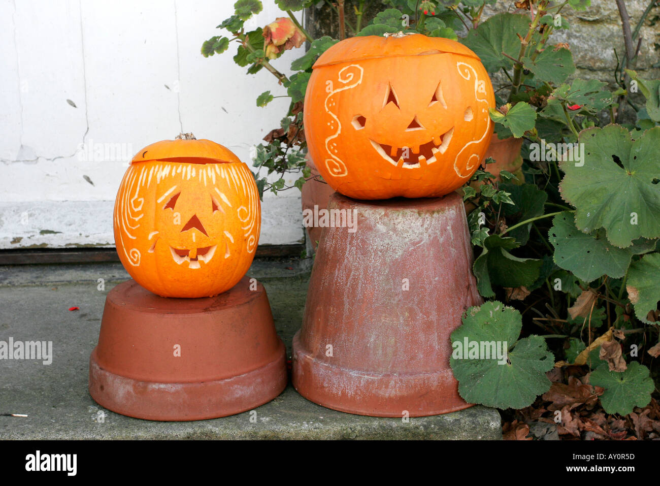 Comical faces carved on a pair of Halloween pumpkins Stock Photo
