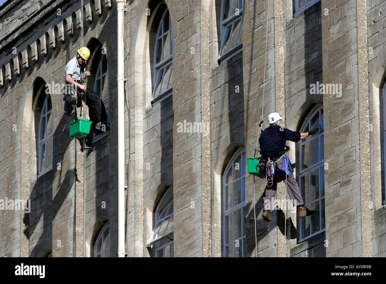 Window cleaners working on the windows of Abbey Mill recently converted