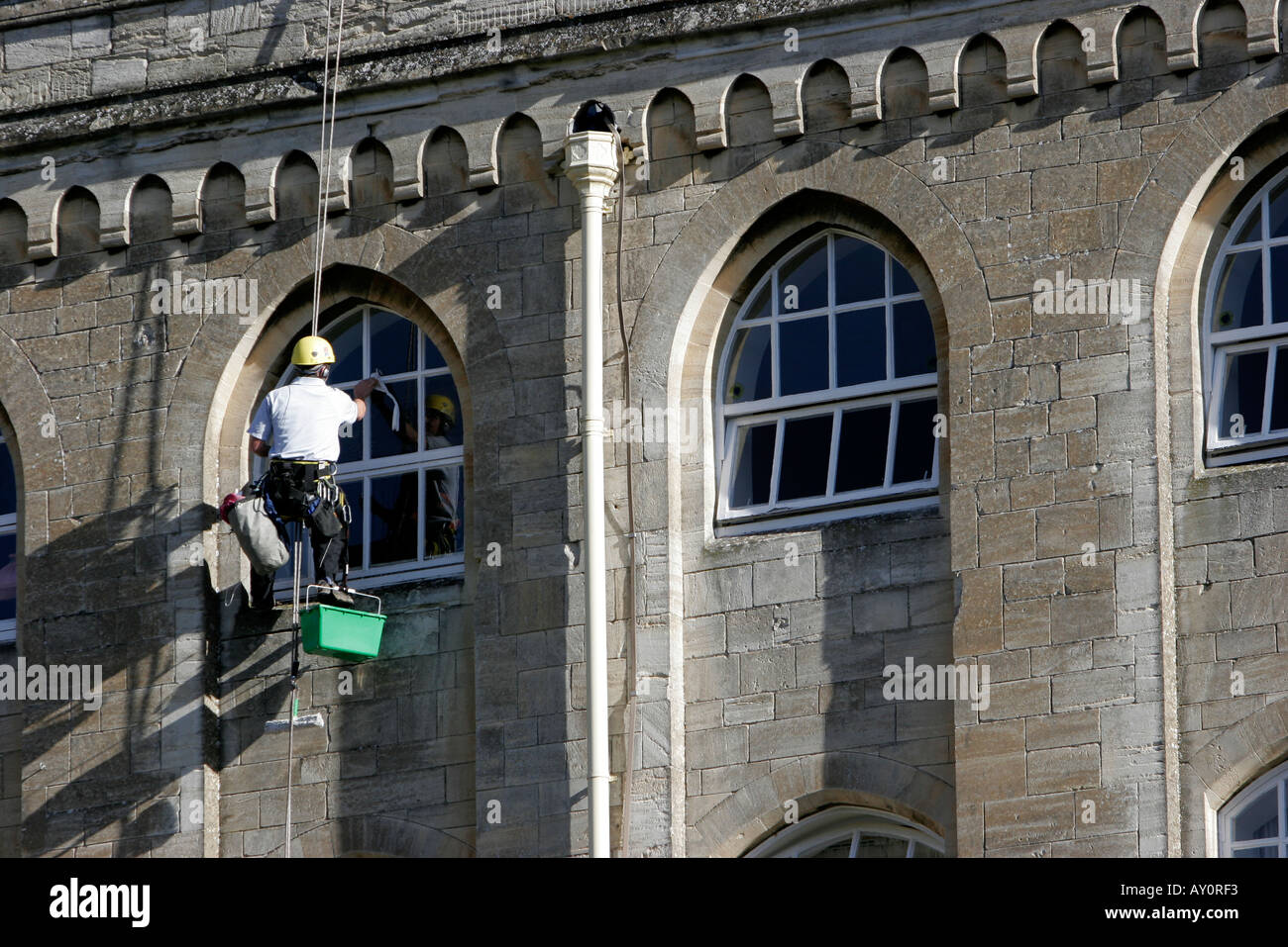 Window cleaners working on the windows of Abbey Mill recently converted