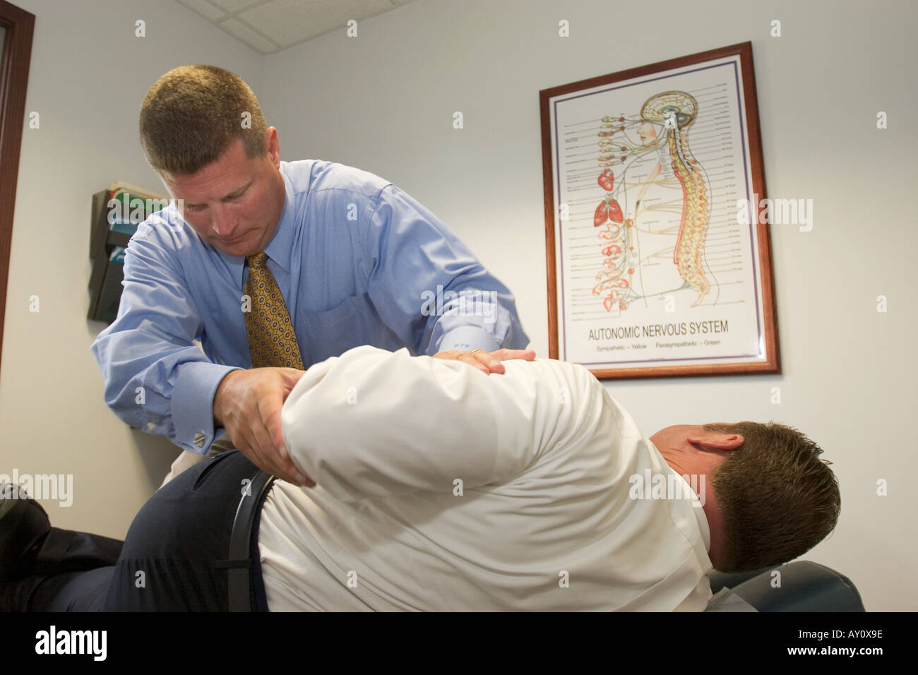 Sterling Heights Michigan Dr William F Goss does an adjustment for a patient in his chiropractic clinic Stock Photo
