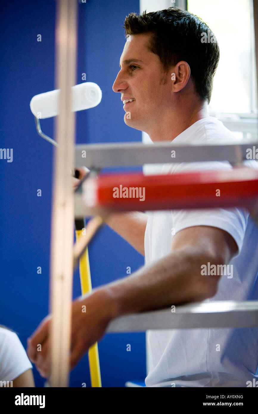 Man on ladder paint hi-res stock photography and images - Alamy