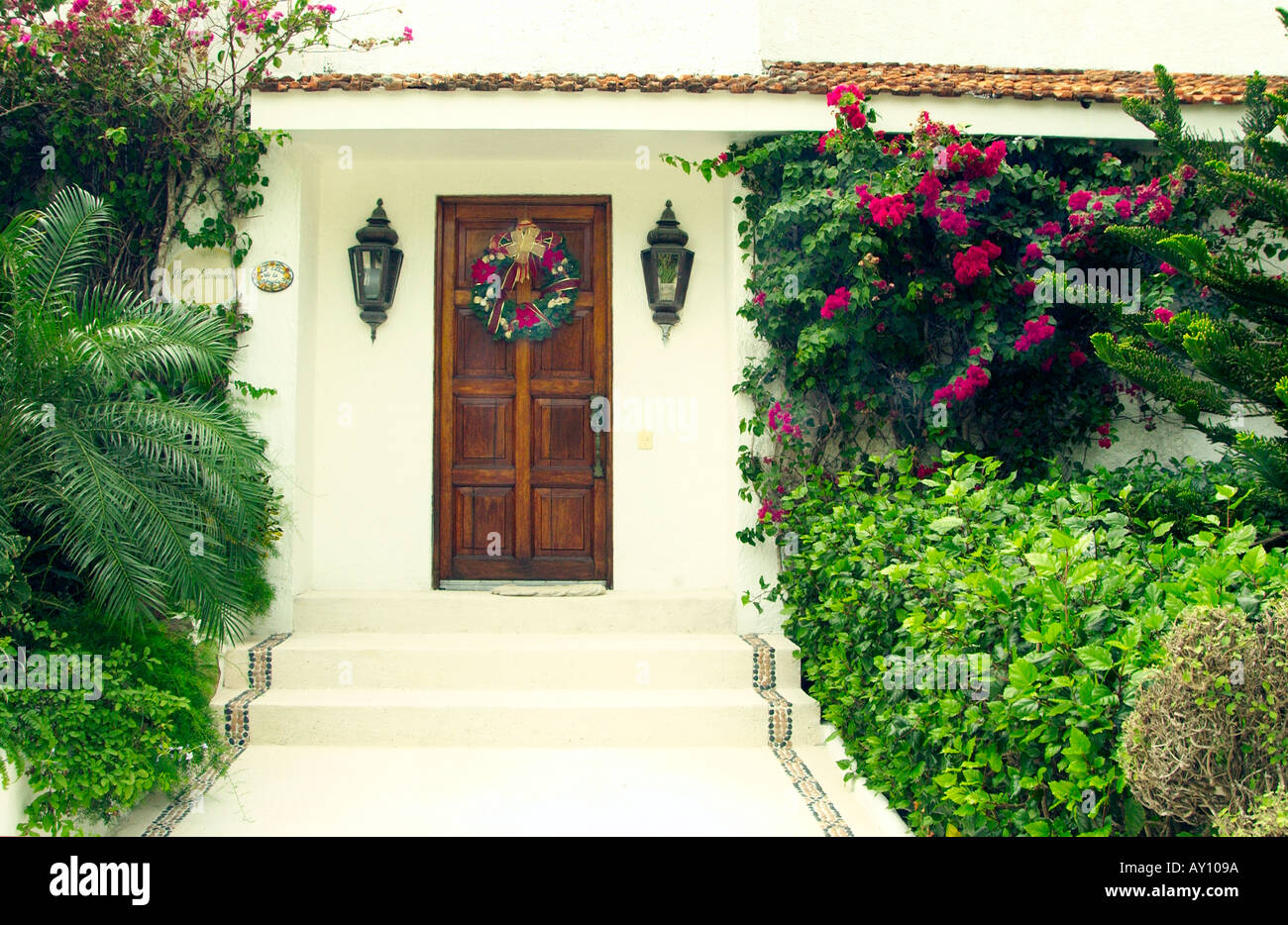 A Christmas wreath adorns the entrance door to a home in Cozumel Mexico Stock Photo