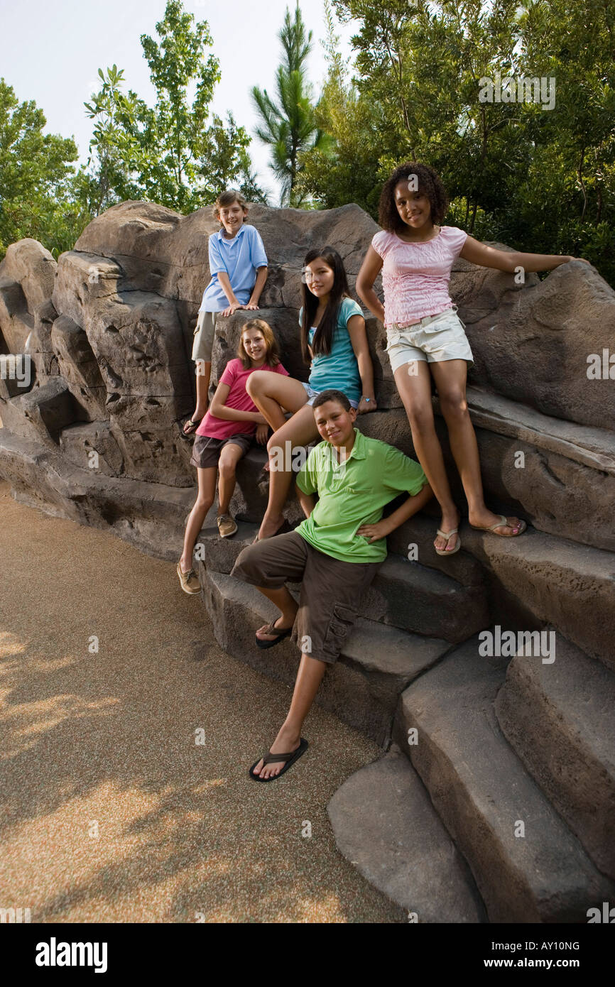 Portrait of cheerful teenagers sitting on the rocks Stock Photo - Alamy