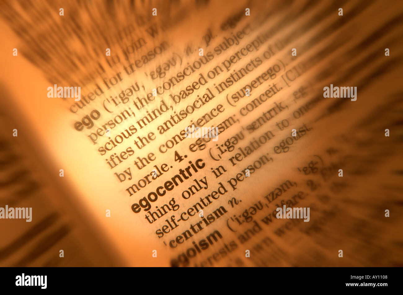 CLOSE UP OF DICTIONARY PAGE SHOWING DEFINITION OF THE WORD EGO EGOCENTRIC Stock Photo