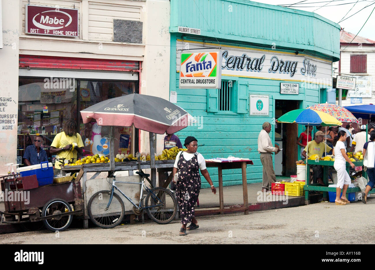 A Belize City street scene with food vendors and native population