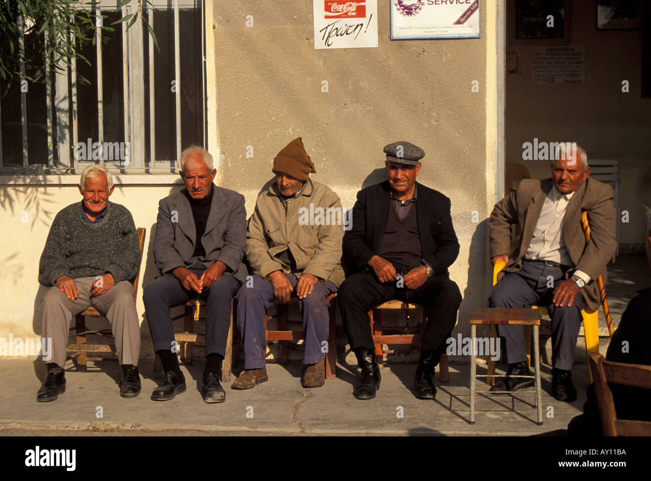 Locals sitting outside a taverna in the sun at Akotiri Cyprus Stock Photo