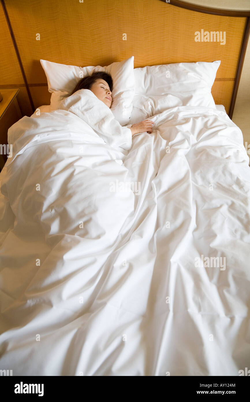 Mature woman sleeping bed vertical hi-res stock photography and images ...