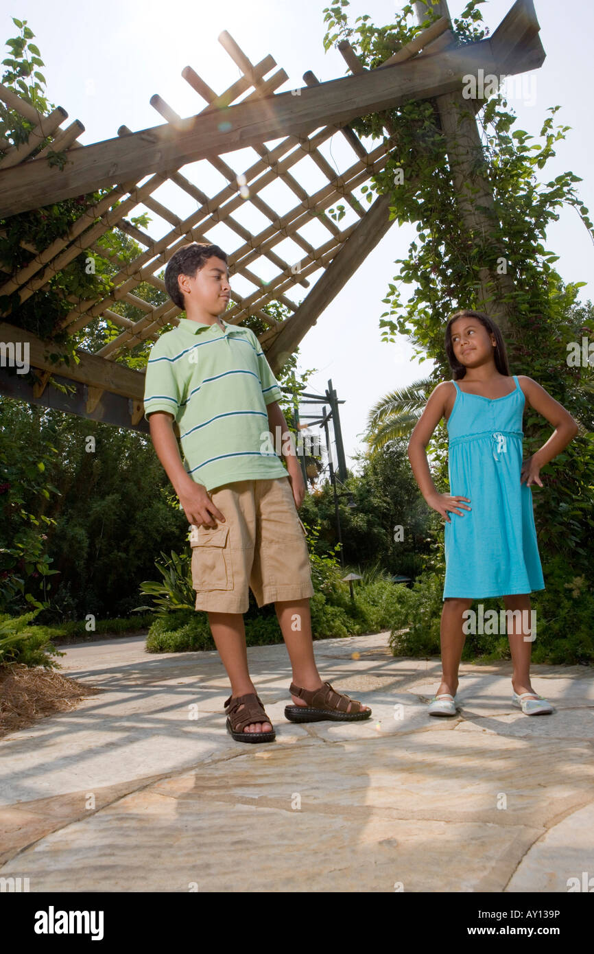 Boy and girl standing together Stock Photo - Alamy