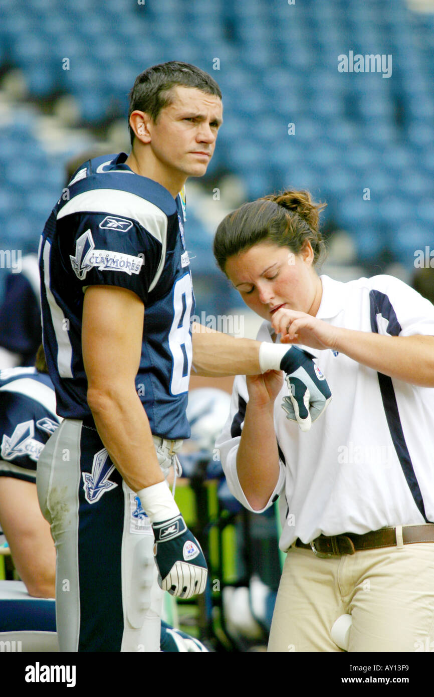 Football player getting hand strapped Stock Photo Alamy