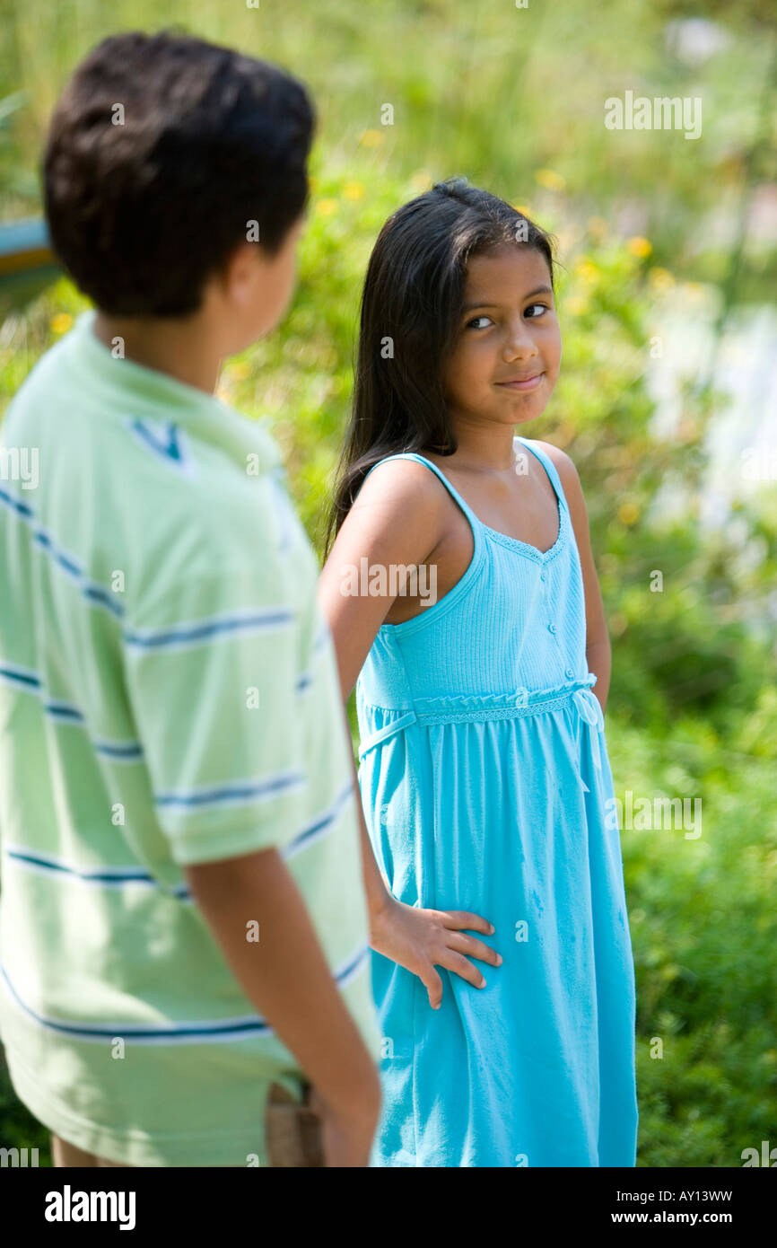 Boy and girl standing together Stock Photo - Alamy
