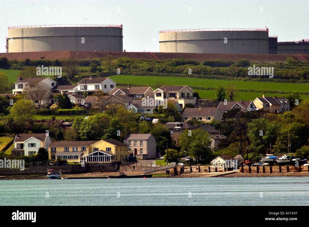 Village of Llanstadwell dominated by the huge storage tanks of an oil