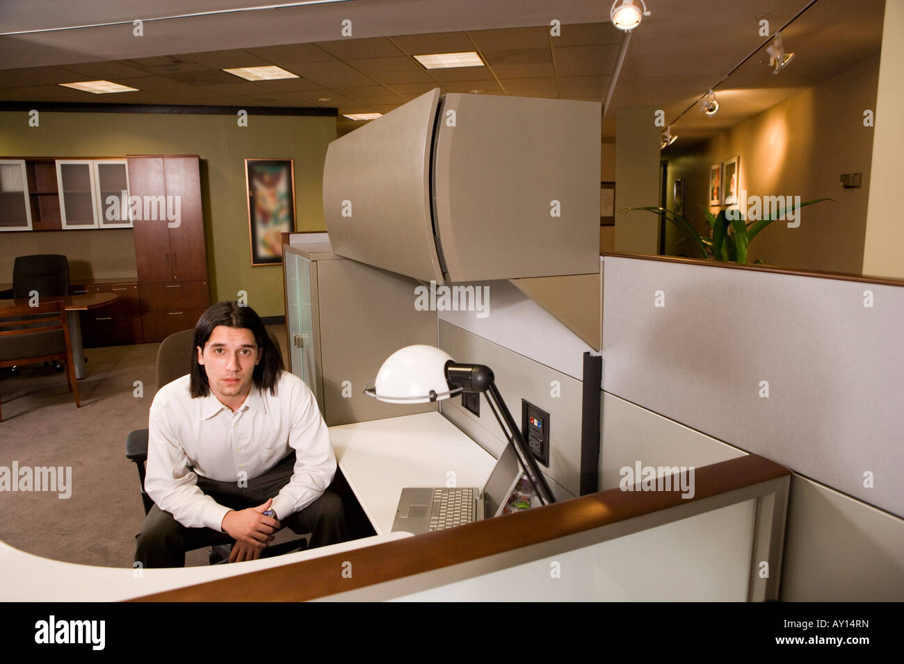 Portrait of a young businessman sitting in an office Stock Photo - Alamy