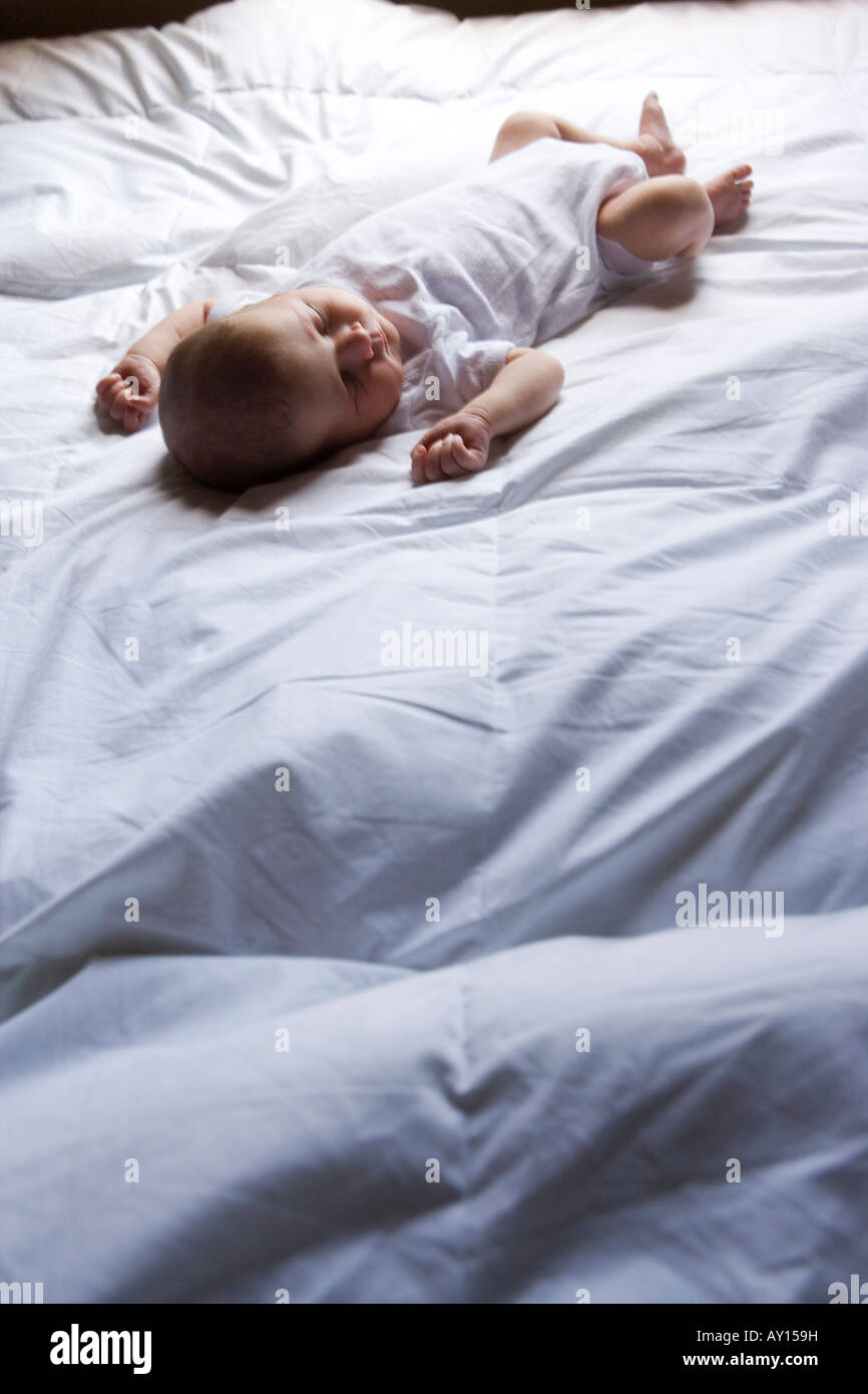 Newborn baby sleeping on the bed Stock Photo Alamy