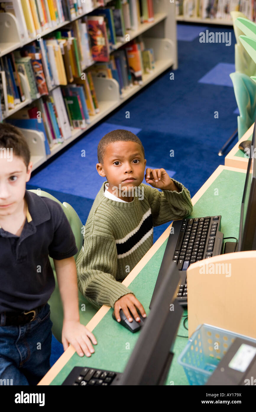 Elevated view of schoolboys using computer in the library Stock Photo ...