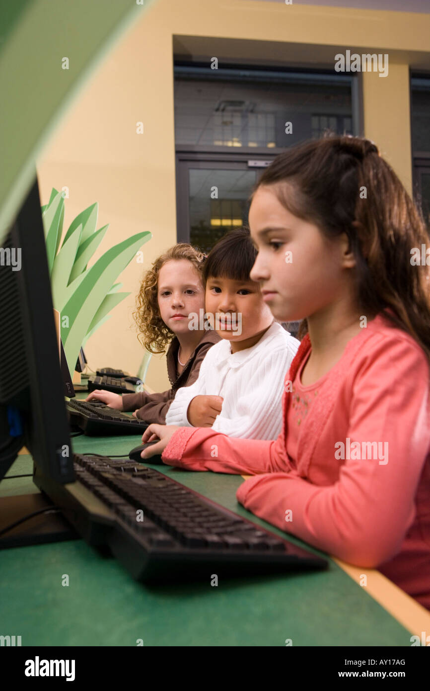 Schoolgirls using computer in the library Stock Photo - Alamy