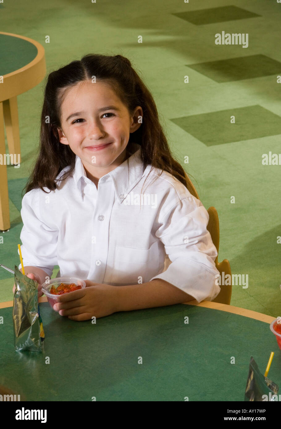 Portrait of a smiling schoolgirl at breakfast Stock Photo - Alamy