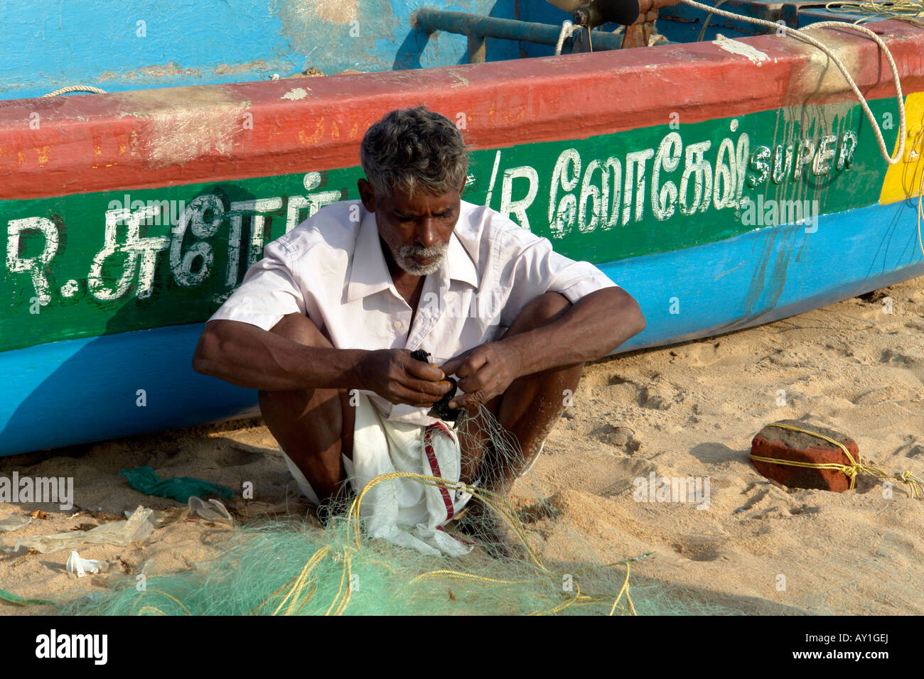 Indian Fisherman Mending Fishing Nets With Decorated Painted Stock